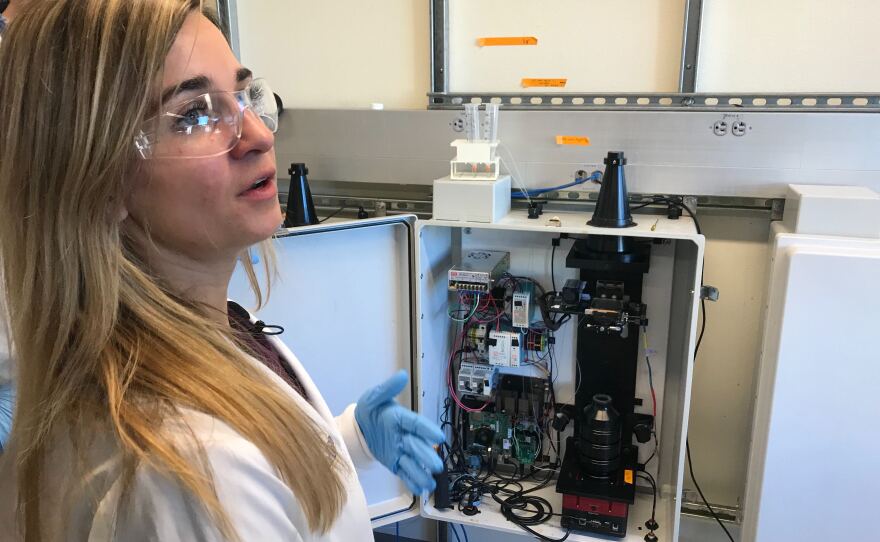 UC San Diego bioengineer Elizabeth Stasiowski shows off a box with an E. coli device and an imaging system, Feb. 6, 2020.