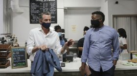 In this June 4, 2020, file photo, California Gov. Gavin Newsom, left, talks with then-Stockton Mayor Michael Tubbs during their stop at Legendary Coffee and Books in Stockton, Calif. 