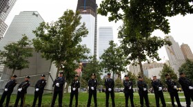 NYPD officers, FDNY firefighters and Port Authority Police line up at one of the entrances of 9/11 Memorial Plaza during the tenth anniversary ceremonies of the September 11, 2001 terrorist attacks at the World Trade Center site, September 11, 2011 in New York City. 
