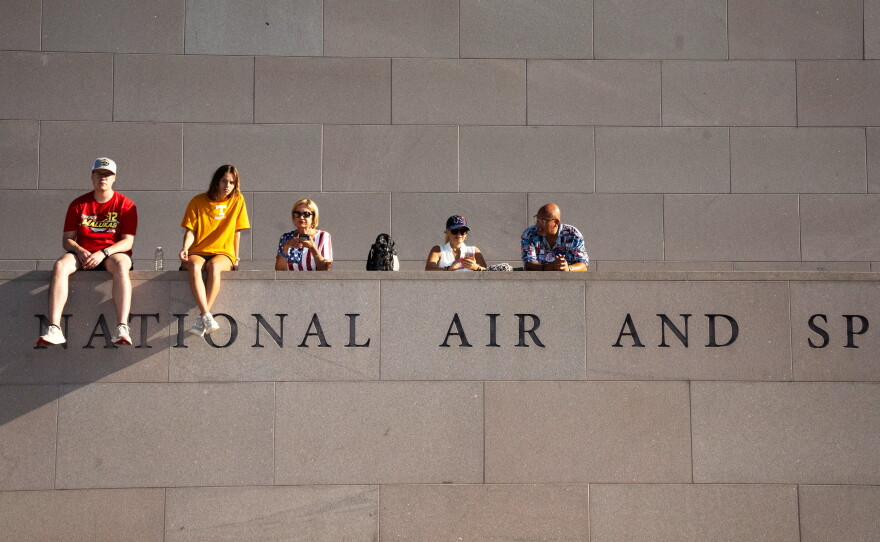 Fans look on from the National Air and Space Museum near the fan zone ahead of the Freedom 250 Grand Prix auto race.