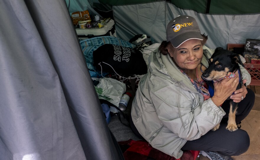 Rosie sits inside of her tent along the outskirts of "the jungle" in Chula Vista, March 8, 2023.
