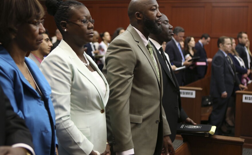 Trayvon Martin's parents Sabrina Fulton, second from left, and Tracy Martin stand in court as the jury leaves the courtroom to deliberate Friday. The jury of six deliberated for more than 16 hours before reaching a verdict Saturday night.