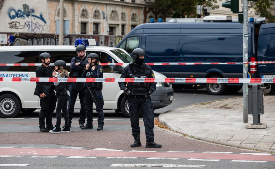 Police block access to a street near the scene of an attack that left two people dead on Wednesday in Halle, Germany. Initial reports indicate a man fired shots outside a synagogue and a kebab shop in the eastern German city.