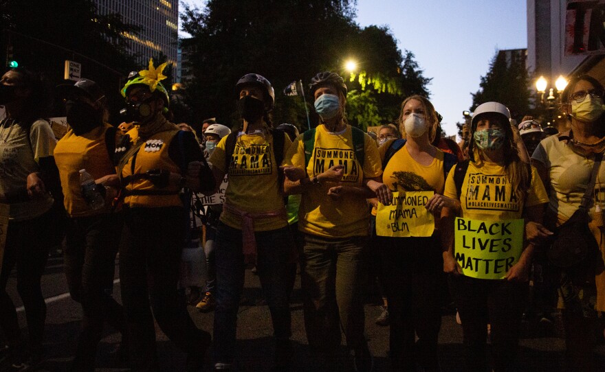 The Wall of Moms marches to the Multnomah County Justice Center in Portland, Ore., July 25, 2020. Portland has sustained protests against police brutality and systemic racism for 58 days.