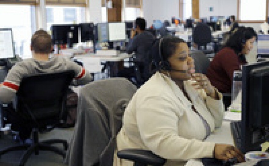 Loretha Cager talks with an applicant at MNSure's call center in St. Paul, Minn., Monday, March 31, 2014. Monday was the open enrollment deadline for signing up for insurance under the Affordable Care Act.