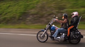 Ron “Stray Dog” Hall and Alicia Soriano Hall ride his Harley.