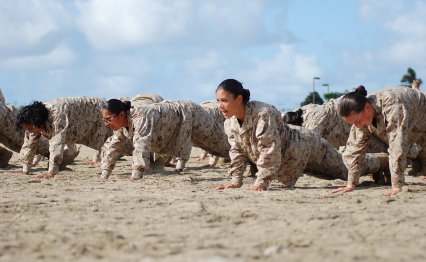 Female Marine recruits hold the push-up position during the confidence building stage of their boot camp training at Camp Pendleton, March 9, 2021.