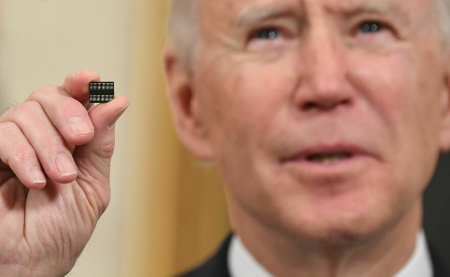 President Biden holds up a microchip at a White House event on Feb. 24, 2021.