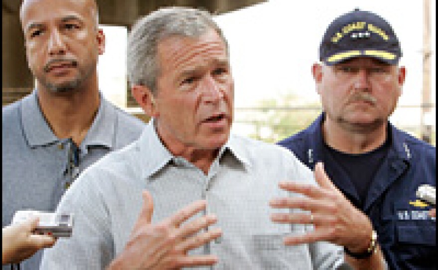 President George Bush is surrounded by New Orleans Mayor Ray Nagin (L), and Vice Admiral of Coast Guard Thad Allen, as he speaks following a tour of New Orleans, Sept. 12, 2005.