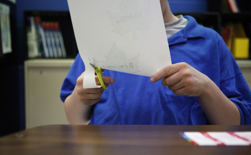 A student cuts out leaves in Lisa Elder's Life Skills class.