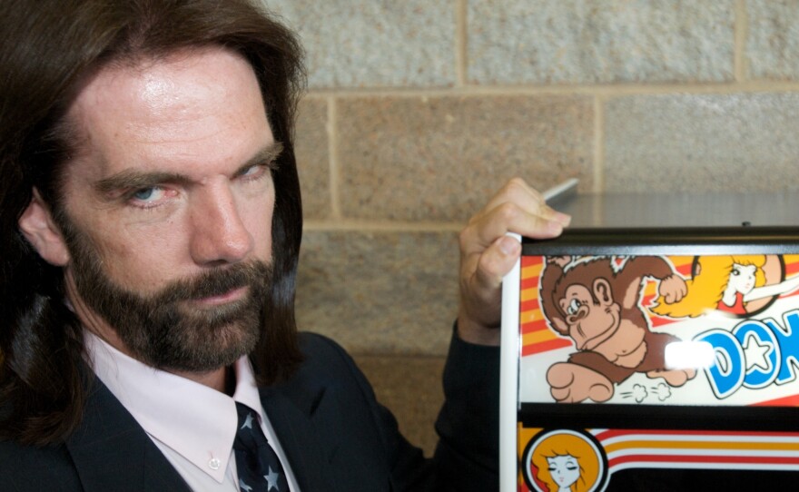Billy Mitchell, described once as "Video Game Player of the Century," poses for a portrait in front of Donkey Kong in Ottumwa, Iowa, in 2009.