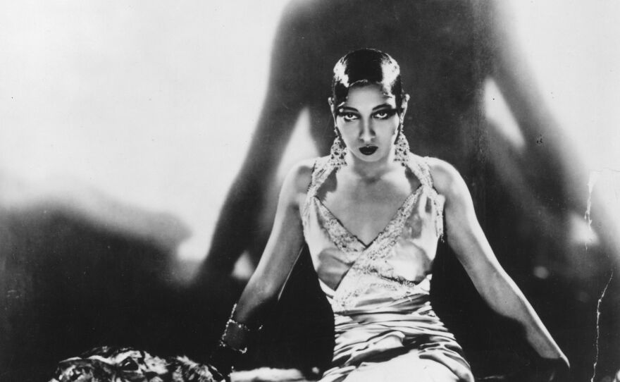 Singer and dancer Josephine Baker, sitting on a tiger rug, circa 1925.