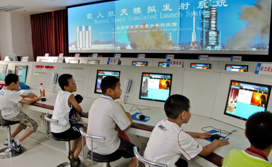 Pint-sized would-be astronauts in a miniature simulated rocket launch center at  a brand new space education center for kids in southern  Beijing.