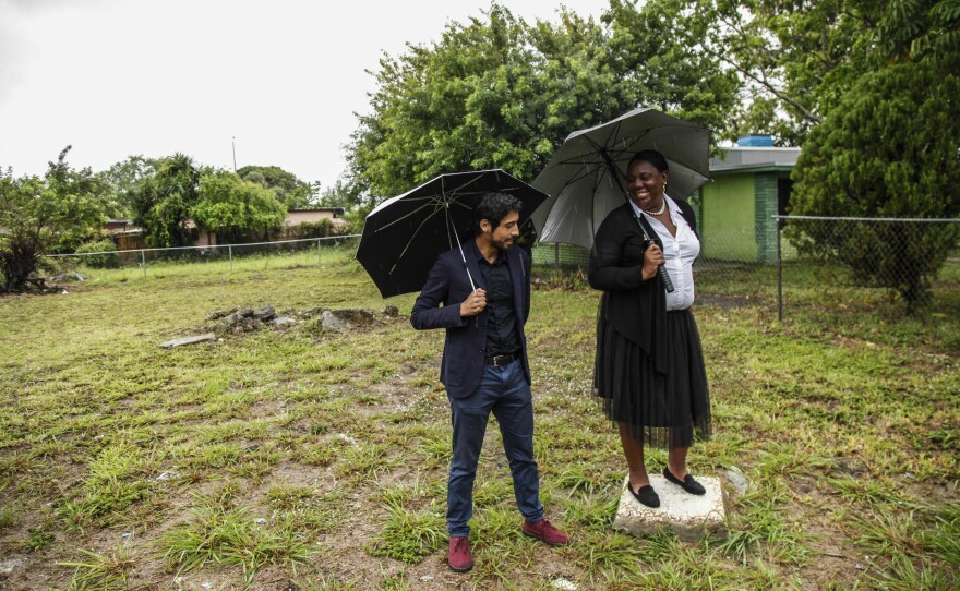 Adrian Madriz (left) with Trenise Bryant at the site of their planned community land trust and apartment building in Miami's Liberty City neighborhood. They say the project will provide housing for low-income locals and help resist so-called "climate gentrification."