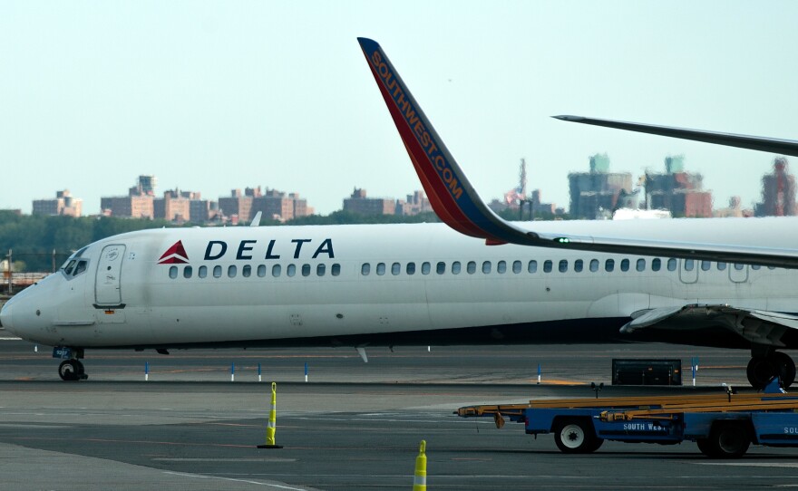 A Delta jet taxis on the tarmac at New York's LaGuardia Airport. About 1,000 Delta flights around the globe were canceled Monday, and hundreds more on Tuesday, after a system outage.