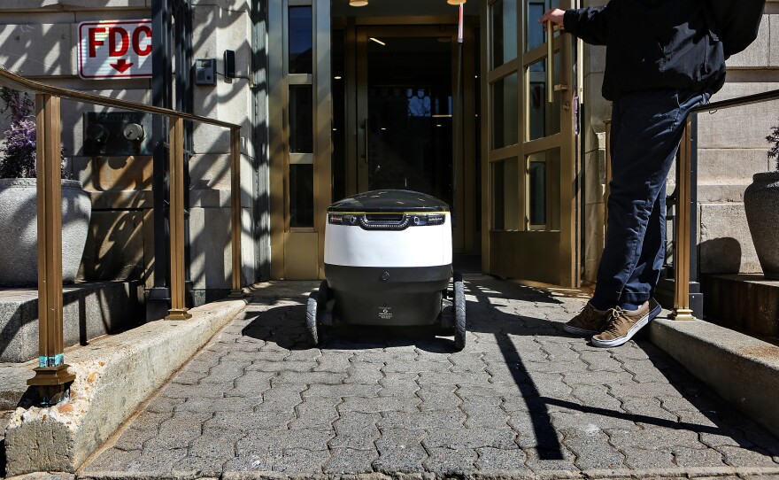 The bot returns to the office. In the District, they frequently travel with someone who helps explain the service — and the robots themselves.