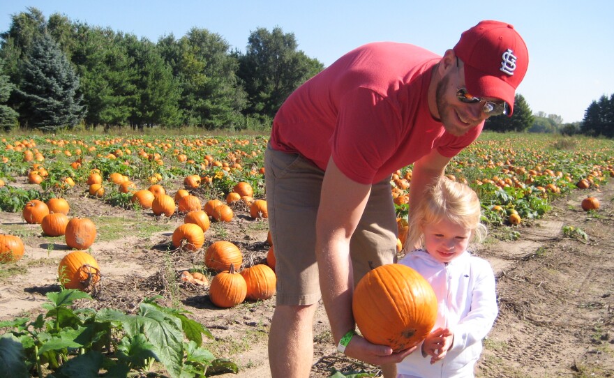 Kevin Coppinger took his nearly 3-year-old daughter, Mae, to choose a pumpkin at Waldoch Farm. The farm added a corn maze about five years ago. Owner Doug Joyer says adding such attractions has allowed him to live solely off income from the farm.