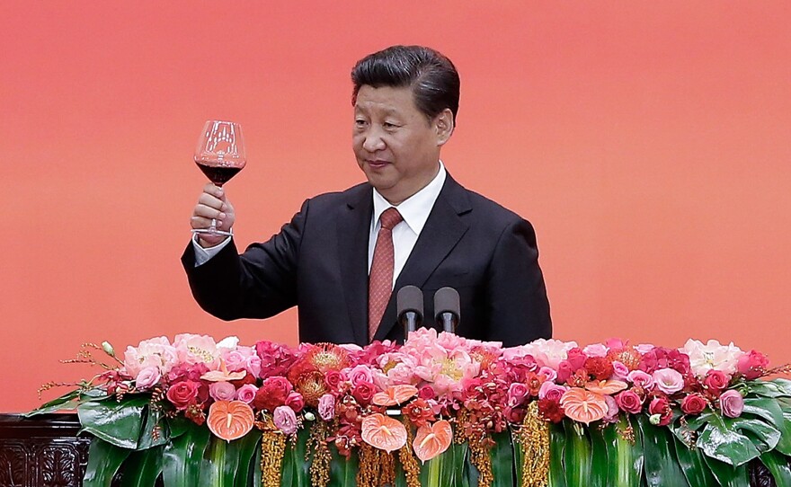 Chinese President Xi Jinping offers a toast after delivering a speech during a reception to mark the 70th anniversary of Japan's surrender during World War II in Beijing on Thursday. Among other things, Xi announced a 300,000 cut in troops.