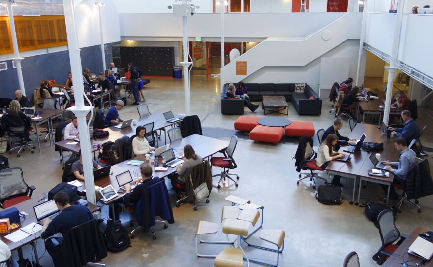 The main atrium of Galvanize allows freelancers to work or come and go as they please, for a monthly membership fee.