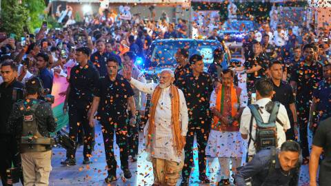 Confetti is sprayed as Indian Prime Minister Narendra Modi, center, waves to supporters upon his arrival at the Bharatiya Janata Party (BJP) headquarters to celebrate victory in the recently held state assembly elections in New Delhi, India, Monday, May 4, 2026.