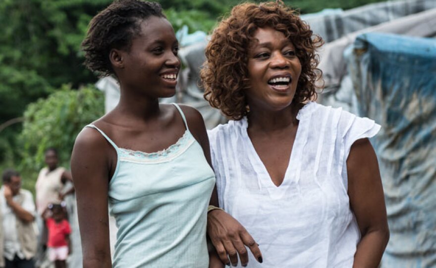 Alfre Woodard with a young girl on location for A PATH APPEARS in Haiti.
