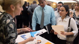 Larraine Weingast (left), a representative from Aflac, talks to Lionel Longsworth and Linette Rodriguez. The two stopped by her booth looking for a job during a diversity job fair in September.