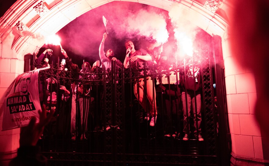Pro-Palestinian supporters climb a fence during demonstrations at The City College Of New York as the NYPD cracks down on protest camps at both Columbia University and CCNY on Tuesday in New York City. A heavy police presence surrounded both campuses on Tuesday as local law enforcement attempts to bring an end to pro-Palestinian protest encampments.