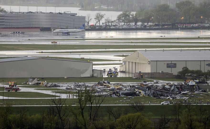 Severe weather damage to Eppley Airfield in Omaha, Neb., can be seen from the Lewis and Clark Monument in Council Bluffs, Iowa on Friday