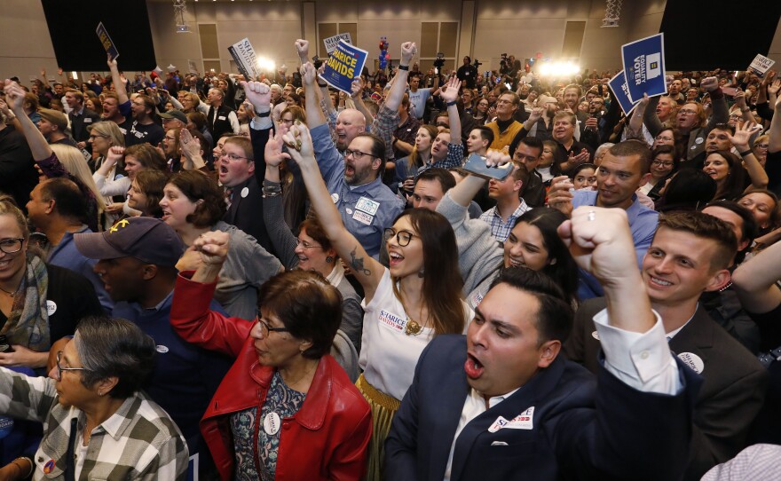 Supporters for Sharice Davids, a Democratic House candidate for Kansas, react as she is declared the winner during a watch party in Olathe, Kan., on Tuesday. Davids defeated incumbent Republican Rep. Kevin Yoder.