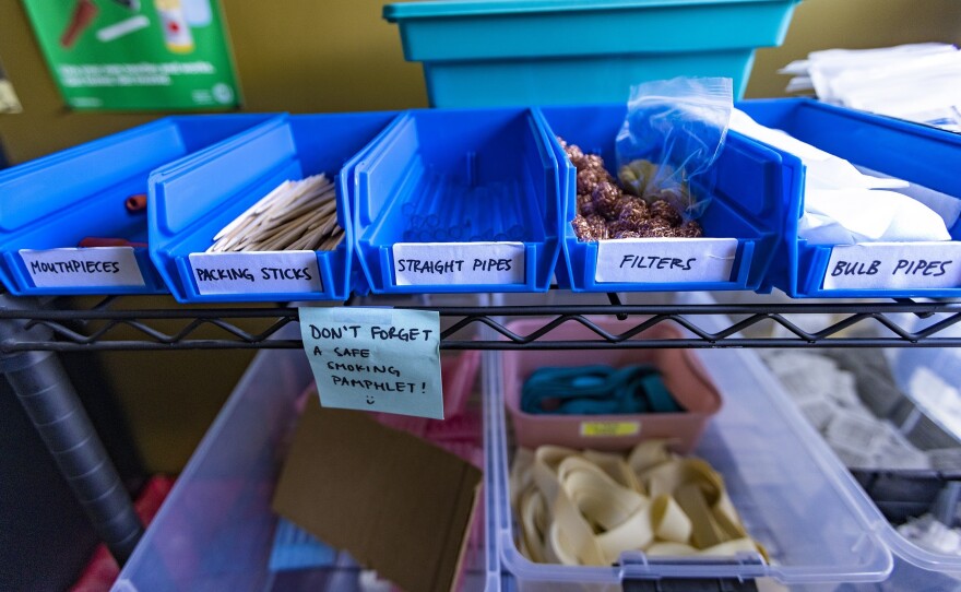 Tapestry Health's harm reduction team hands out items such as filters and pipes to people from its mobile unit.