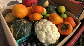 Fruits and vegetables are stacked inside of carboard boxes on a red wagon, Dec. 6, 2021.