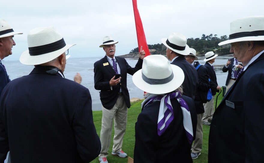 Wayne Craig (center) gives last-minute instructions to the volunteer docents who lead tours and have knowledge of the cars.