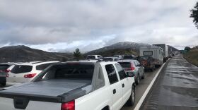 Cars wait in traffic on I-8 East while snow plows clear the road following a winter storm, Dec. 26, 2019. 
