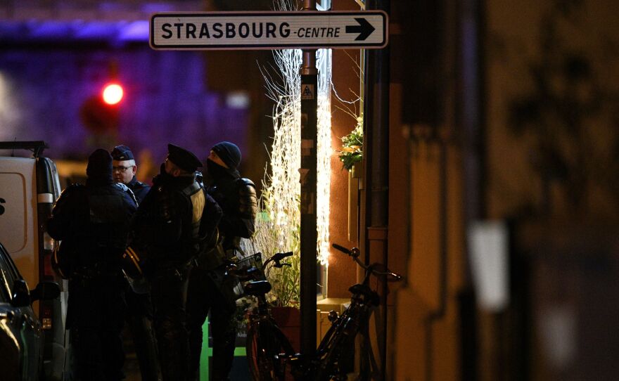 Police officers stand near the place where Cherif Chekatt, the alleged gunman who had been a fugitive since allegedly killing three people at a popular Christmas market in Strasbourg, France, was shot dead by police on Thursday.