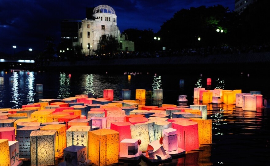 Paper lanterns to commemorate the victims of the bombing of Hiroshima float in the Motoyasu River in front of the Atomic Bomb Dome, in Hiroshima, Japan, on Saturday.