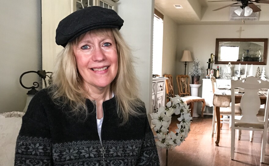 Adrien Koch, 62, sits in the bedroom of her northern Idaho home, which is twice as big and half as expensive as the one she sold in California.