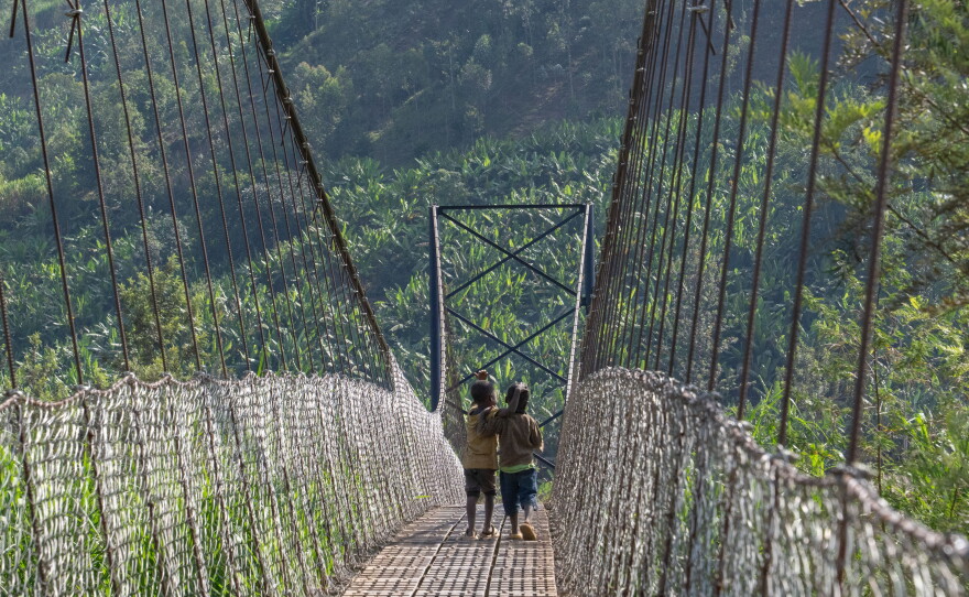 Two youngsters cross the Cyangoga Suspension Bridge.