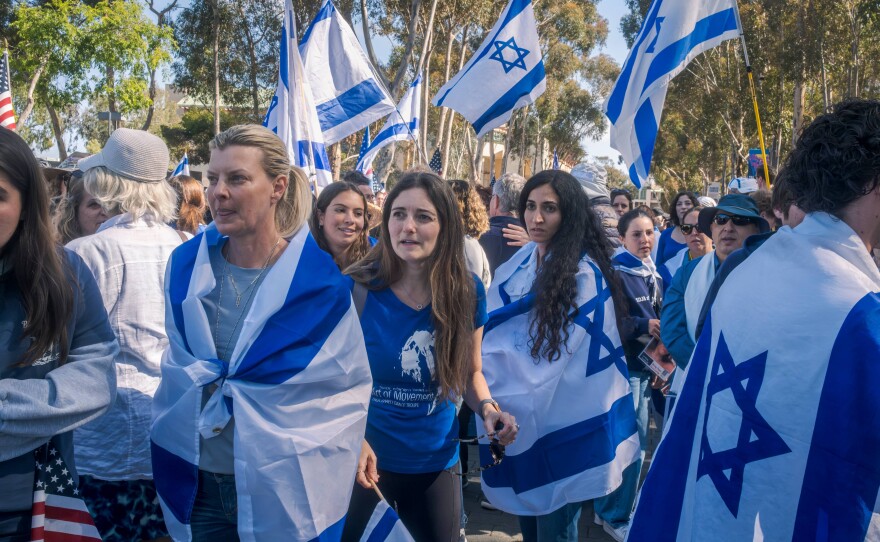Pro-Israel counter-protesters wear and wave Israeli flags near the UC San Diego pro-Palestinian encampment, May 5, 2024.