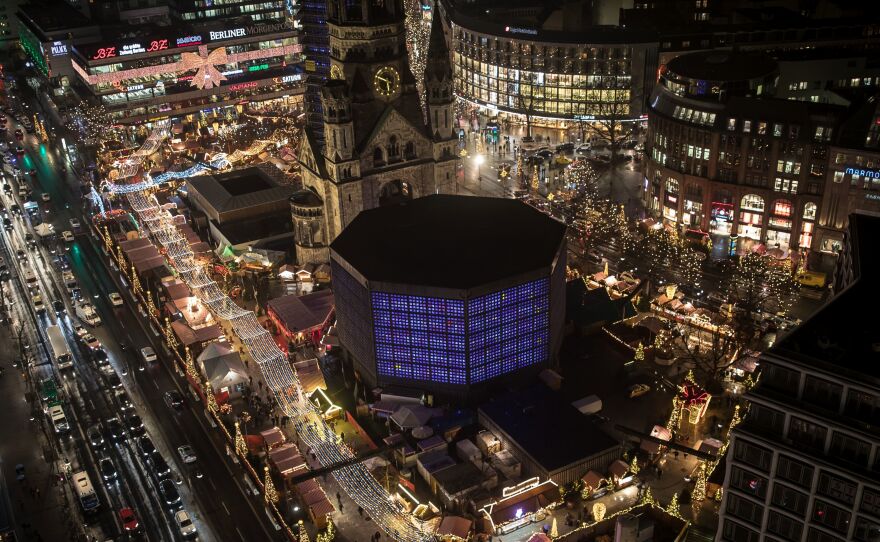 The Christmas market near the Kaiser Wilhelm Memorial Church in Berlin continues on Dec. 22. Somber but determined not to be cowed, visitors flocked to a Berlin Christmas market as it reopened three days after being struck by a deadly truck assault.
