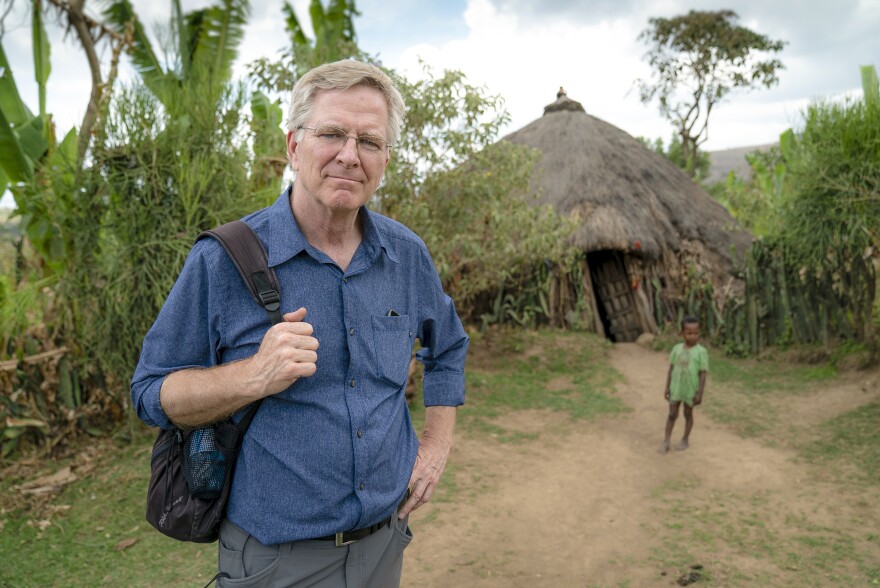 Rick Steves in a village near Hawassa, Ethiopia. A young child stands in the background.