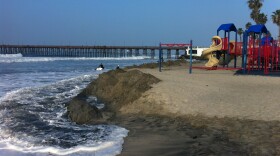 Sand is banked up around the Oceanside beach playground to protect it from the high surf on Jan. 21, 2015.