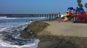 Sand is banked up around the Oceanside beach playground to protect it from the high surf on Jan. 21, 2015.