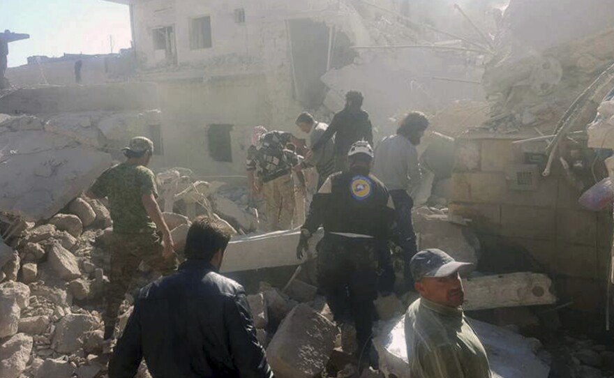 Civil Defense workers and Syrian citizens inspect damaged buildings after airstrikes hit earlier this month in Darat Izza, western Aleppo province, Syria. Airstrikes had halted in eastern Aleppo but have now resumed.