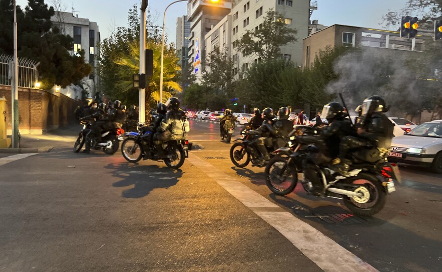 In this photo taken by an individual not employed by the Associated Press and obtained by the AP outside Iran, anti-riot police arrive to disperse demonstrators during a protest over the death of a young woman.