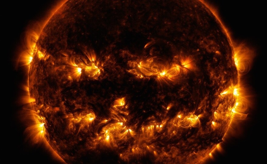 Active regions on the sun gave it the appearance of a jack-o'-lantern. This image is a blend of 171 and 193 angstrom light as captured by the Solar Dynamics Observatory on Oct. 8, 2014.