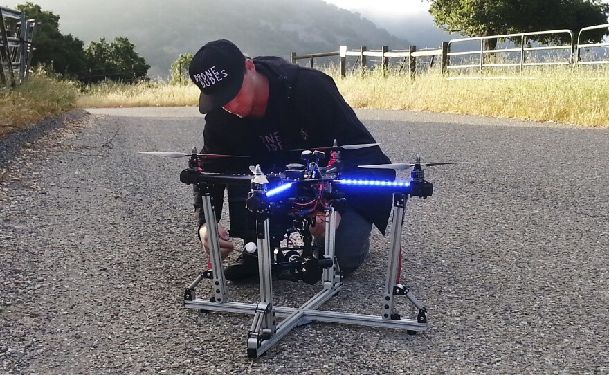 Jeff Blank, of Los Angeles-based Drone Dudes, prepares a quadcoptor for takeoff. The drone has to chase a motorcycle down a hill.