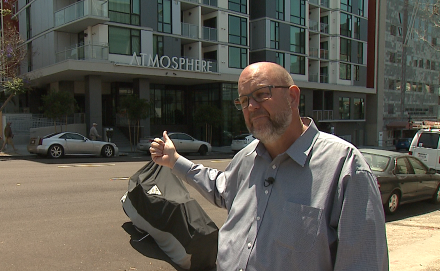 Homeless advocate Michael McConnell points to Atmosphere, a 205-unit affordable housing complex with 51 apartments for the homeless, June 8, 2017.