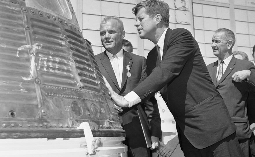 Glenn and President John F. Kennedy inspect the Friendship 7 capsule that Glenn rode into space. Kennedy presented the Distinguished Service medal to Glenn at Cape Canaveral, Fla., on Feb. 23, 1962. Vice President Lyndon Johnson is in the background.