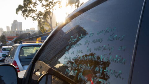A note written in a parked car window in San Diego pleads with police to not tow the car, June 27, 2023.