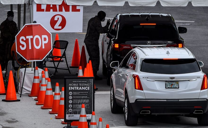 People wait for a COVID-19 test Wednesday at a walk-in and drive-through coronavirus testing site in Miami Beach, Fla. Miami-Dade County is the epicenter of the pandemic in Florida.